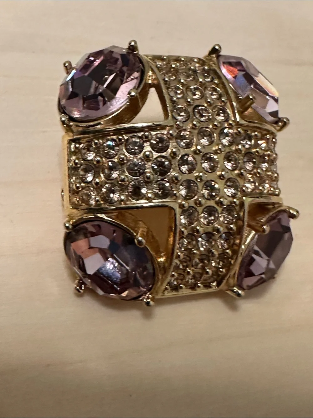Monet gold-tone brooch with an abstract geometric design with purple stones